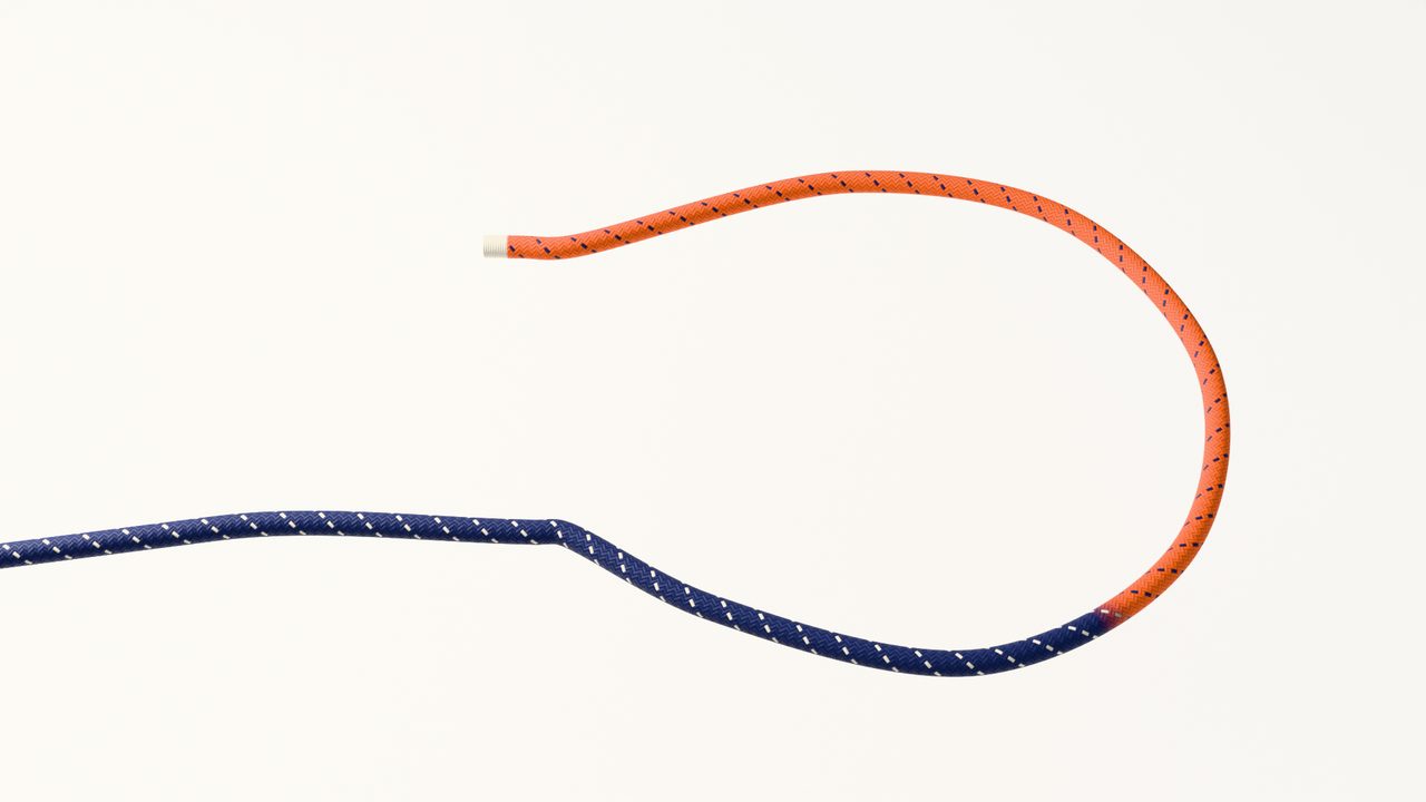 An untied rope: the navy standing part comes in from the left and loops round to the orange working end